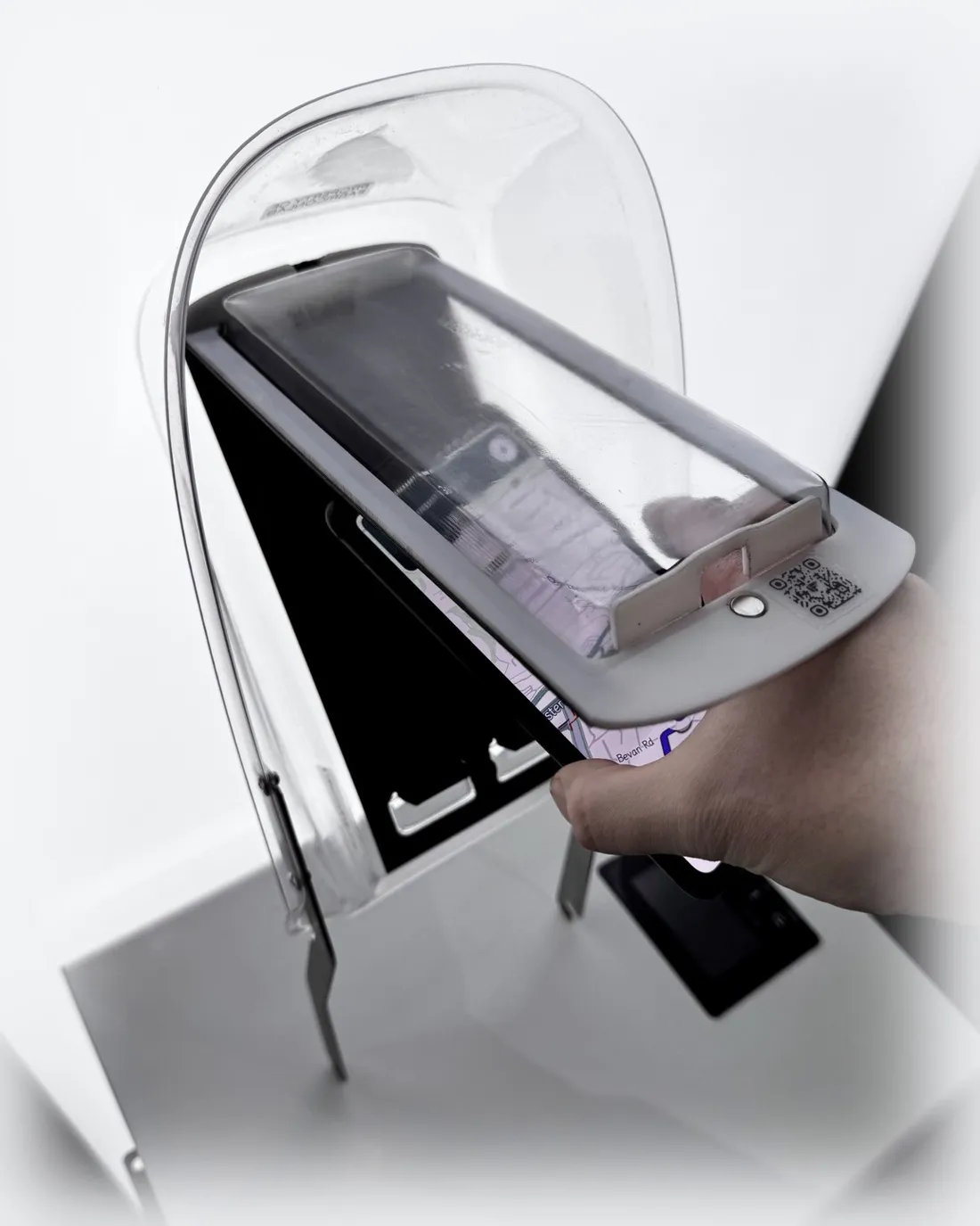Smartphone being placed into the EyesUp dock's cushioned enclosure