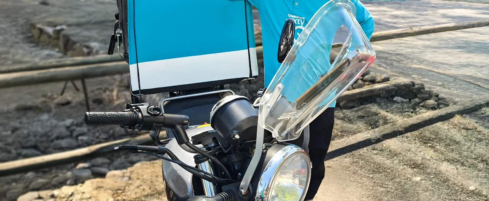 Side view of a delivery motorcycle with the EyesUp visor fitted above the headlight