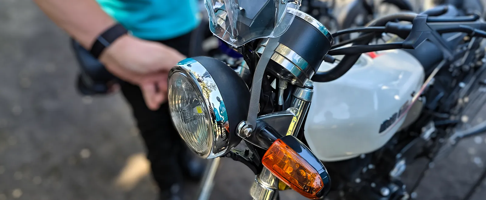 Close-up of the EyesUp dock mounted on a delivery motorcycle's existing headlight brackets